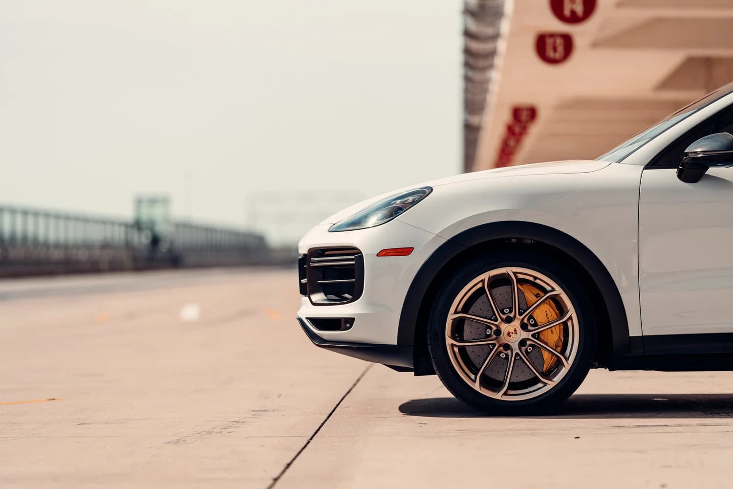 White Porsche Cayenne with bronze wheels